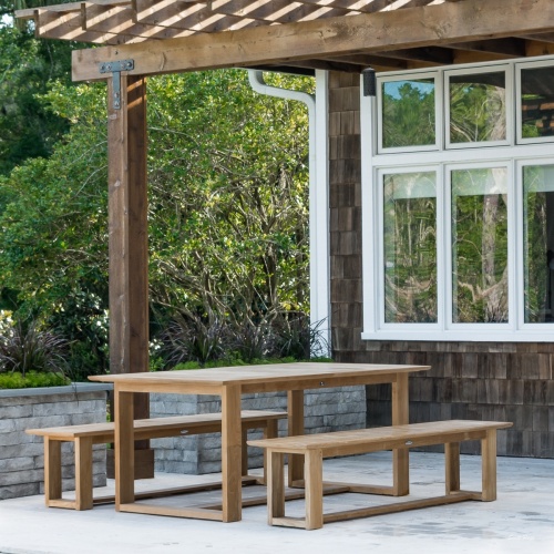 13909 Horizon teak 6 foot long Backless Bench dining picnic set on concrete patio with trees and house in background