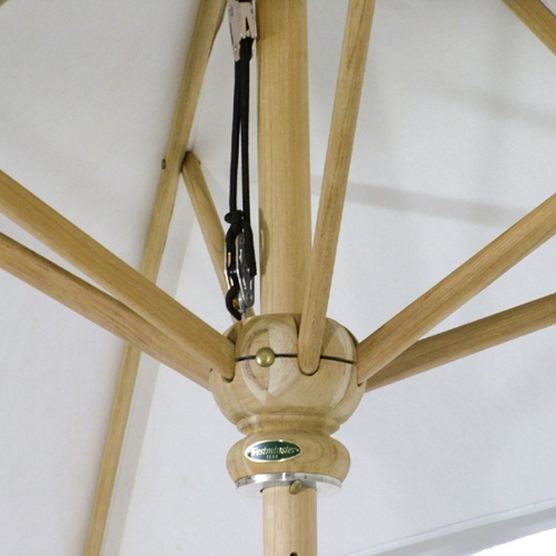 17540F Somerset 8 foot Round teak Umbrella extended on round patio set next to brick house and french doors in background
