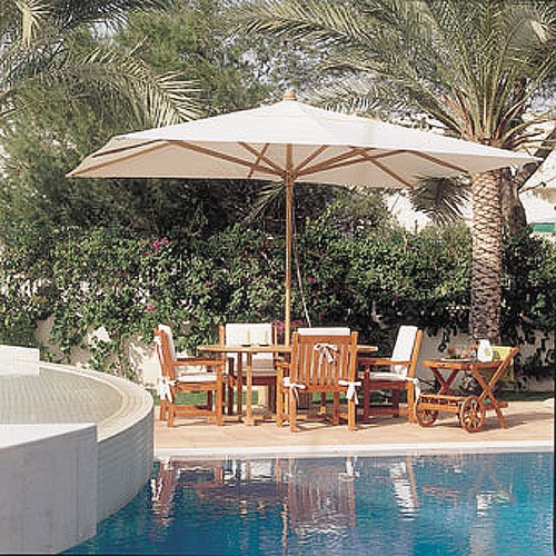 17640F Grand 10 feet Rectangular teak Umbrella in dining set on grass with apples bread plates and bowls on top with trees dock and water view in background