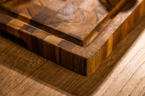 19124 Butcher Block 20 inch Rectangle Charcuterie Cutting Board showing closeup view of the cutting board corner on a counter top