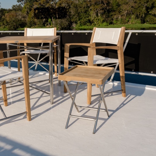 28815DP odyssey ottoman with serving tray on boat deck with two Odyssey folding chairs in background