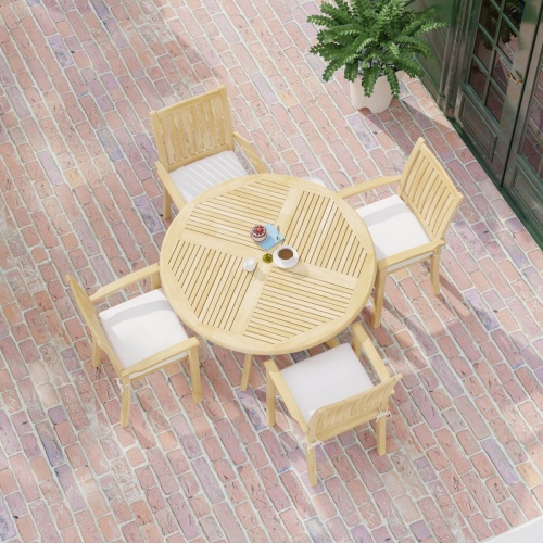 70027 Grand Hyatt 5 pc Dining Set on brick patio showing 2 with table settings with optional seat cushions outdoors between landscape trees and store fronts in background