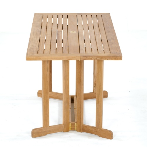 70048 Nevis Barbuda teak Dining Set with optional seat cushions in angled end view on terrace overlooking buildings in background