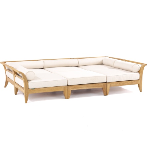 70100 Aman Dais 6 pc Daybed Set front angled showing two corner three end pieces and one ottoman on stone patio with trees plants and house in background