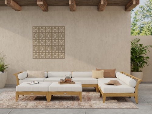 70101 Aman Dais 8 pc Daybed showing 2 corner sectionals and 4 end sectionals and 2 ottomans with cushions in front view on tiled patio with house and concrete fence in the background