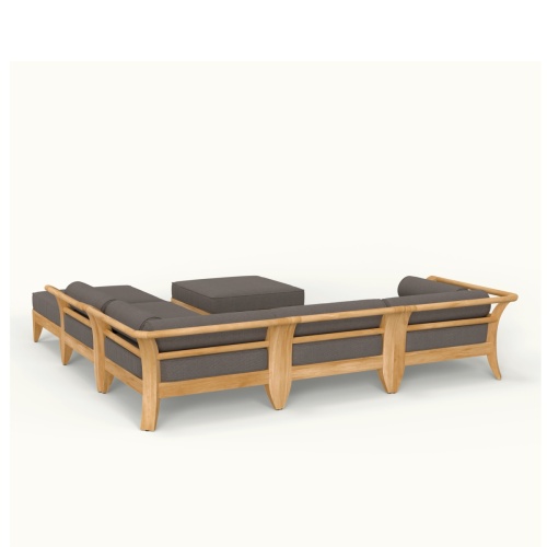  70121 Aman Dais 6 piece teak sectional set on a stone patio right side aerial view tray of green apples potted plants and grass lawn and trees in background