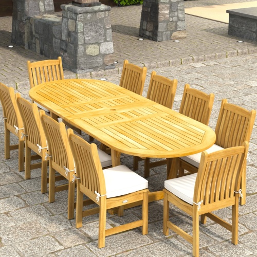70166 Montserrat Veranda 11pc Dining Set with optional cushions on patio in angled aerial end view with pergola with hanging plants and vines and plants and hillside in background