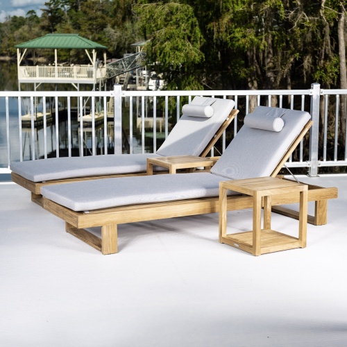 70308 Horizon teak Chaise Lounger with optional cushion showing 6 in aerial angled view facing pool with building and trees in background