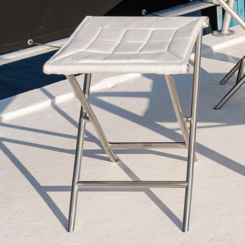 70460 Odyssey teak and stainless steel ottoman without the removable teak tray closeup side view on boat deck