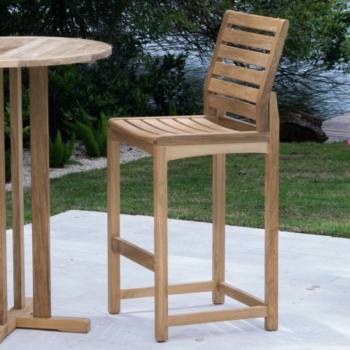 11812 Somerset Side Barstool on concrete patio next to grass area with lake and trees in background