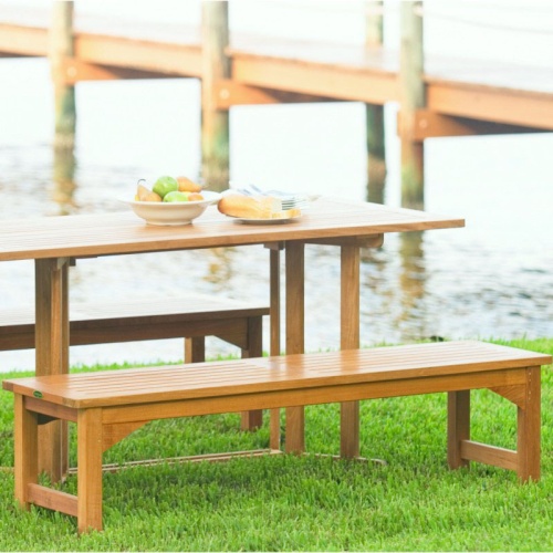 13929 Veranda teak 5 foot long Backless Bench angled side view on stone patio with bushes in background