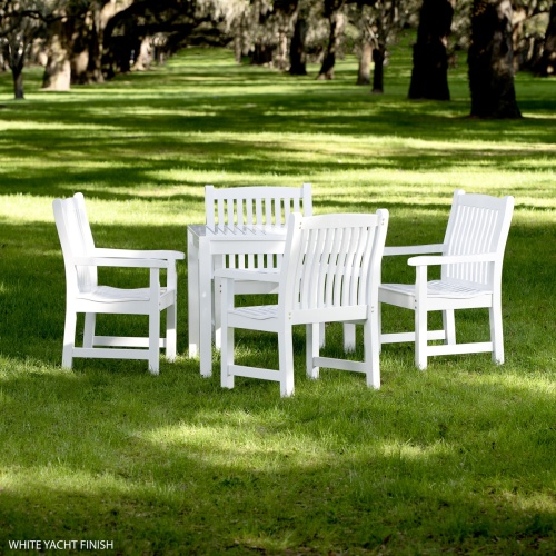 70425 Veranda 5pc Square Teak Dining Set with whote finish on grass field with trees in background