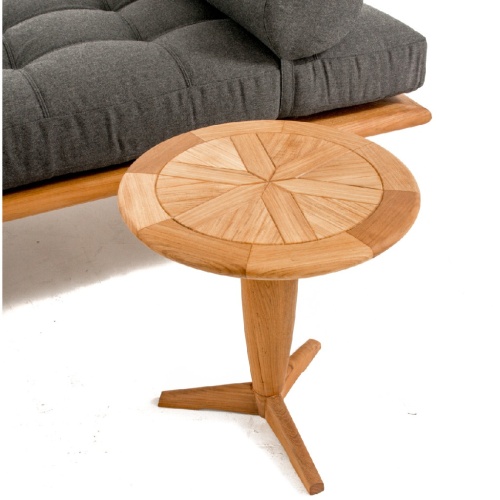 16815dp saloma teak daybed with cushion angled beside teak round side table on white background