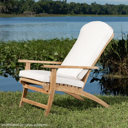 70000 Adirondack Chair with cushions side view on green grass with vegetation and lake background