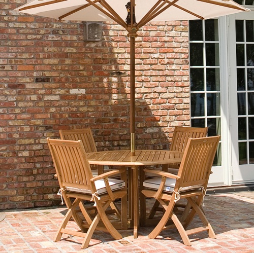 70066 Barbuda Round 5 piece Folding Dining Set on brick patio with house and french patio doors in background