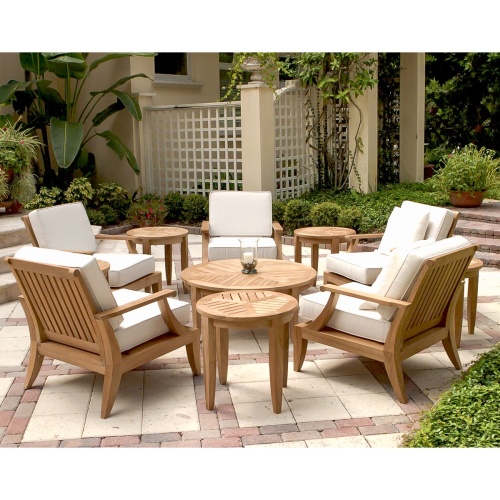 70106 Laguna 11 piece lounge set on stone patio pillar candle holder on coffee table stairs with potted plant and landscape shrubs and two lattice panels and house in background