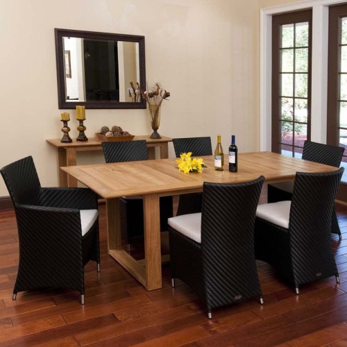 70243 Valencia 7 piece Dining Set with 2 wine bottles and yellow flowers on table center on wood floors indoors wall mirror side table with 2 pillar candles vase of dried flowers on back wall