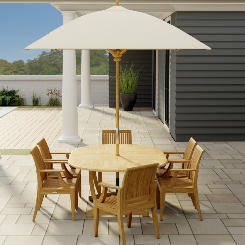 70306 Martinique 7 pc Teak Dining Set with optional rectangular umbrella in side view on stone patio with a house and door and window in the background