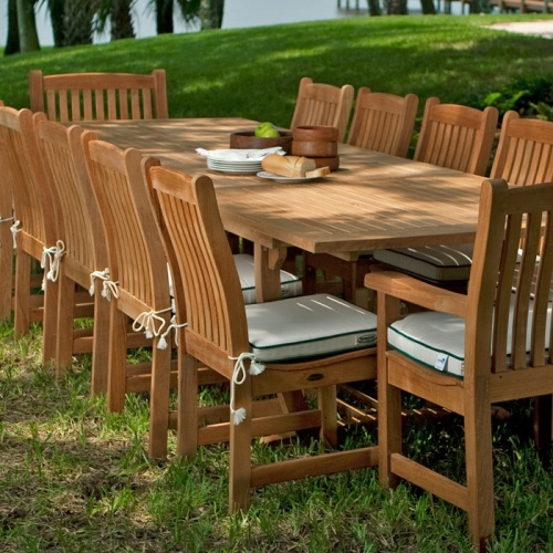 11315 Veranda Teak Side Chair with Veranda Extension Table on grass with lake in background