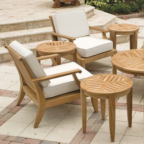 12152DP Laguna Teak Lounge Chair showing 2 Chairs with 3 side tables and coffee table in angled aerial view on paver patio with stairs and shrubs in background