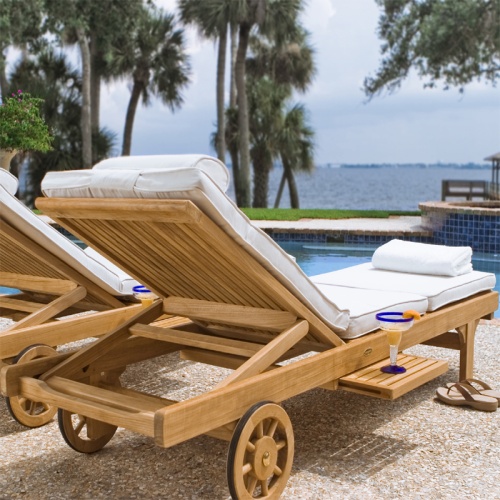 16512s Somerset teak Chaise Lounger on stone patio with sandals next to chaise and back view showing two facing pool palm trees and ocean view in background