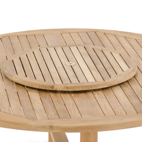 18705 round 32 inch teak lazy susan on table inserted in the teak table umbrella hole with white background
