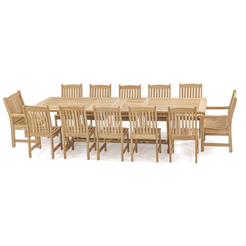 70017 Grand Veranda 13 piece dining set with optional seat cushions in end view showing vase of flowers and wine glasses with bottle of wine on patio next to a stone wall 