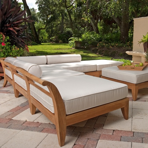 70121 Aman Dais 6 piece sectional set angled on a stone patio tray of green apples potted plants with grass lawn and trees in background