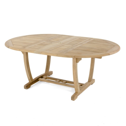 70306 Martinique 7 pc Teak Dining Set with optional rectangular umbrella in end view on stone patio with 2 pillars of house and a potted plant a privacy wall and trees in the background