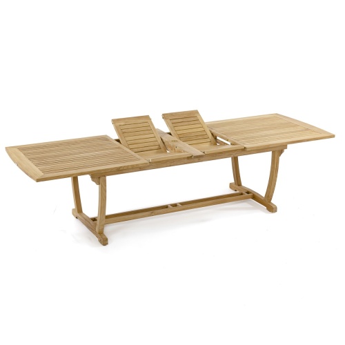 70017 Grand Veranda 13 piece dining set with optional seat cushions bowl of apples plate of bread serving plates and bowls grass lawn brick house round teak dining set in background