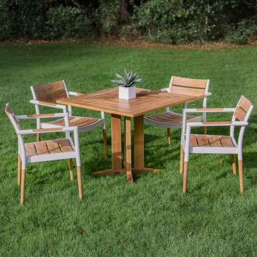 70452 Bloom Pyramid Bistro Dining Set of 4 Bloom teak and powder coated aluminum dining chairs and Pyramid 36 inch square teak dining table with potted plant on grass in background