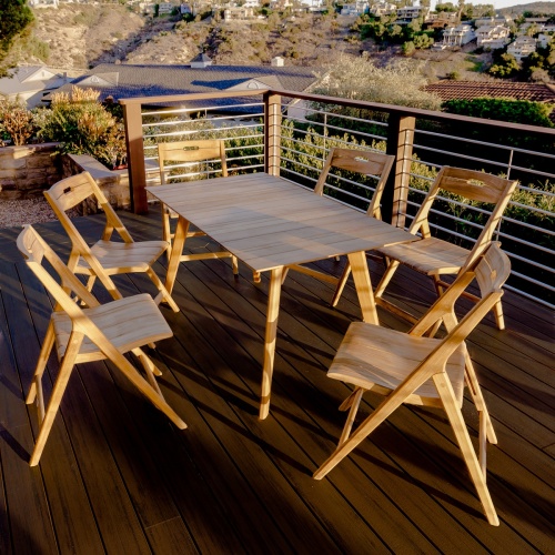 70518 Surf 7 piece teak folding Dining Set showing Surf Rectangular Teak Dining Table and 6 Surf Chairs with optional seat cushions in side view on white background