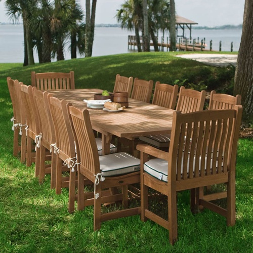 70891 veranda grand extension table with veranda dining and side chairs with optional seat cushions on grass by lake