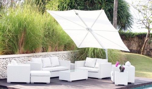 sps25100ffb spectra solo umbrella only white canopy over white sofa set on wood deck stone railing behind deck tall grass shrubs and grass in background