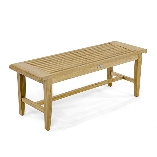 13915 Laguna 4 foot long teak Backless Bench on concrete walkway with grass in background