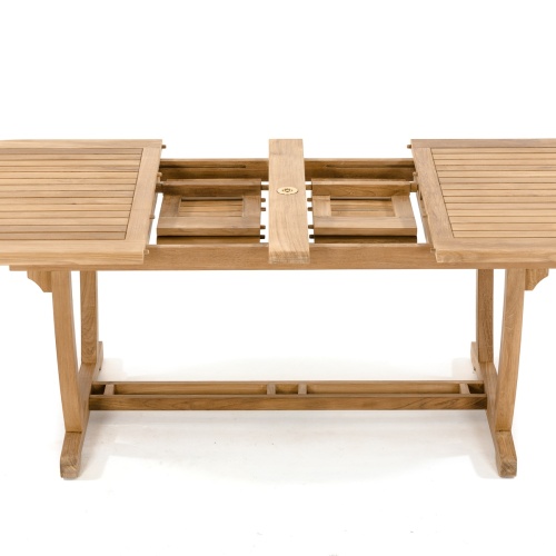 15504 Montserrat Teak Oval Dining Table in side view showing closeup of double butterfly leaf extensions stored in table on white background