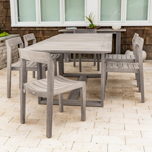 15900 Horizon Teak Table in angled top view showing closeup of table leaf out and water pitcher white plate with limes 3 sparkling water bottles on concrete terrace