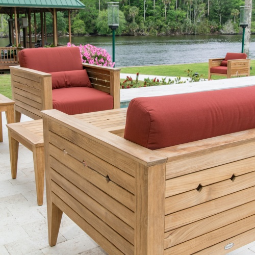 70507 Craftsman lounge chair showing 3 with cushions closeup angled view on concrete patio with potted flowering plants and lake in background