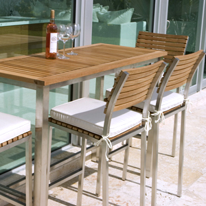 21510 Vogue Bar Stool right view with optional canvas color cushion on seat on concrete patio in front of vogue rectangular bar table