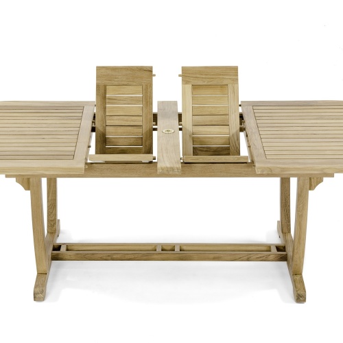 15504 Montserrat Teak Oval Table angled showing double butterfly leaf extensions partially extended in V position in storage area on white background