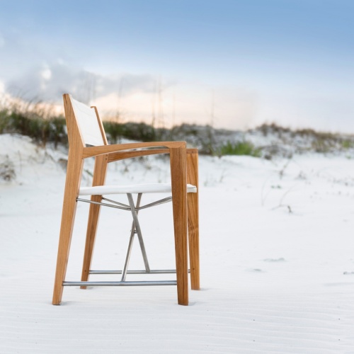 12915F Odyssey Folding Director Chair facing right on sandy beach with sand dunes with sea grass and sunset sky background