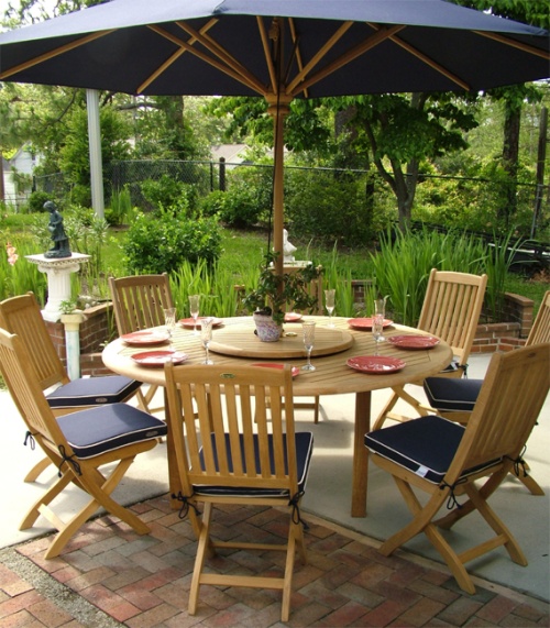 70026 Buckingham Barbuda teak 9 piece Dining Set of teak 72 inch round dining table and 8 teak side chairs with optional Lazy Susan and optional umbrella in center on patio