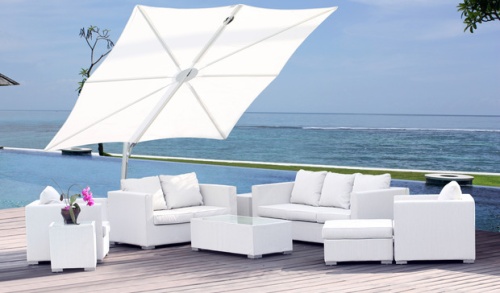 SP25100SET Spectra Solo Umbrella and Paver Base on terrace over deep seating set with pool grass area ocean and blue sky in background