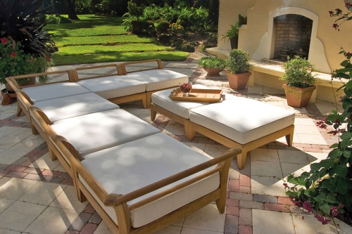 70101 Aman Dais 8 pc Daybed with cushions aerial view on a stone patio right side aerial view tray with red grapes potted plants and grass lawn and trees in background