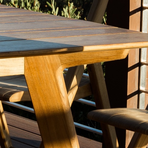 15917 Surf Teak Rectangle Dining Table showing closeup corner view of table top on wood deck