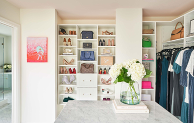 Walk in closet stocked with shoes and clothes