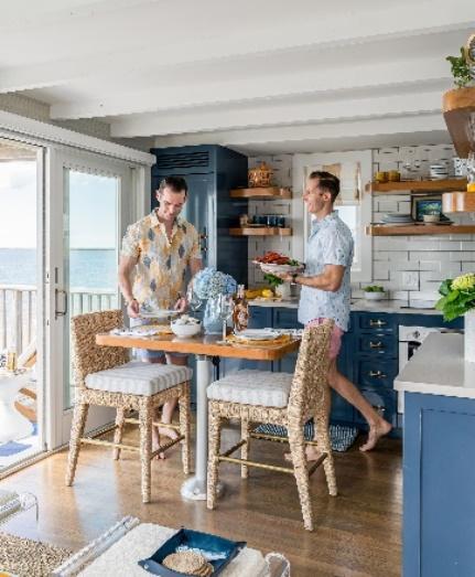 An Image Trevor Fulmer and Jim in the dining room and kitchen of their seaside condo with an ocean view.